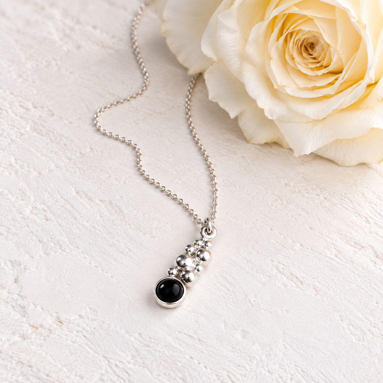 Small pendant with beads and a black onyx stone