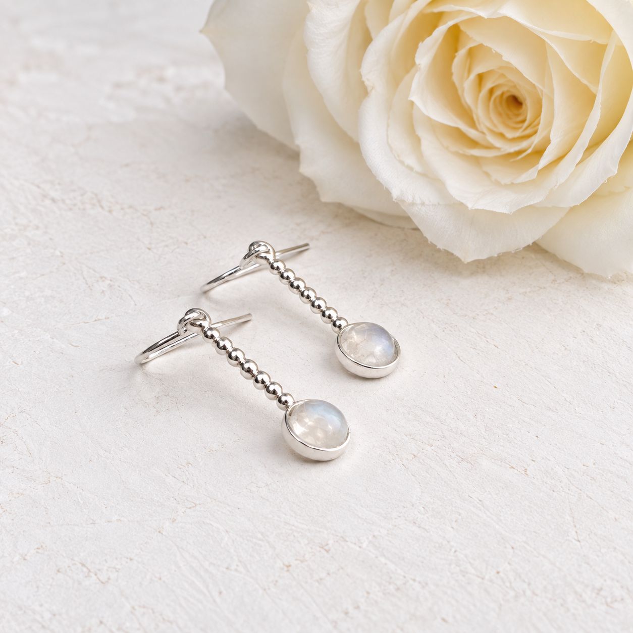 Small drop earrings with tiny spheres and moonstones