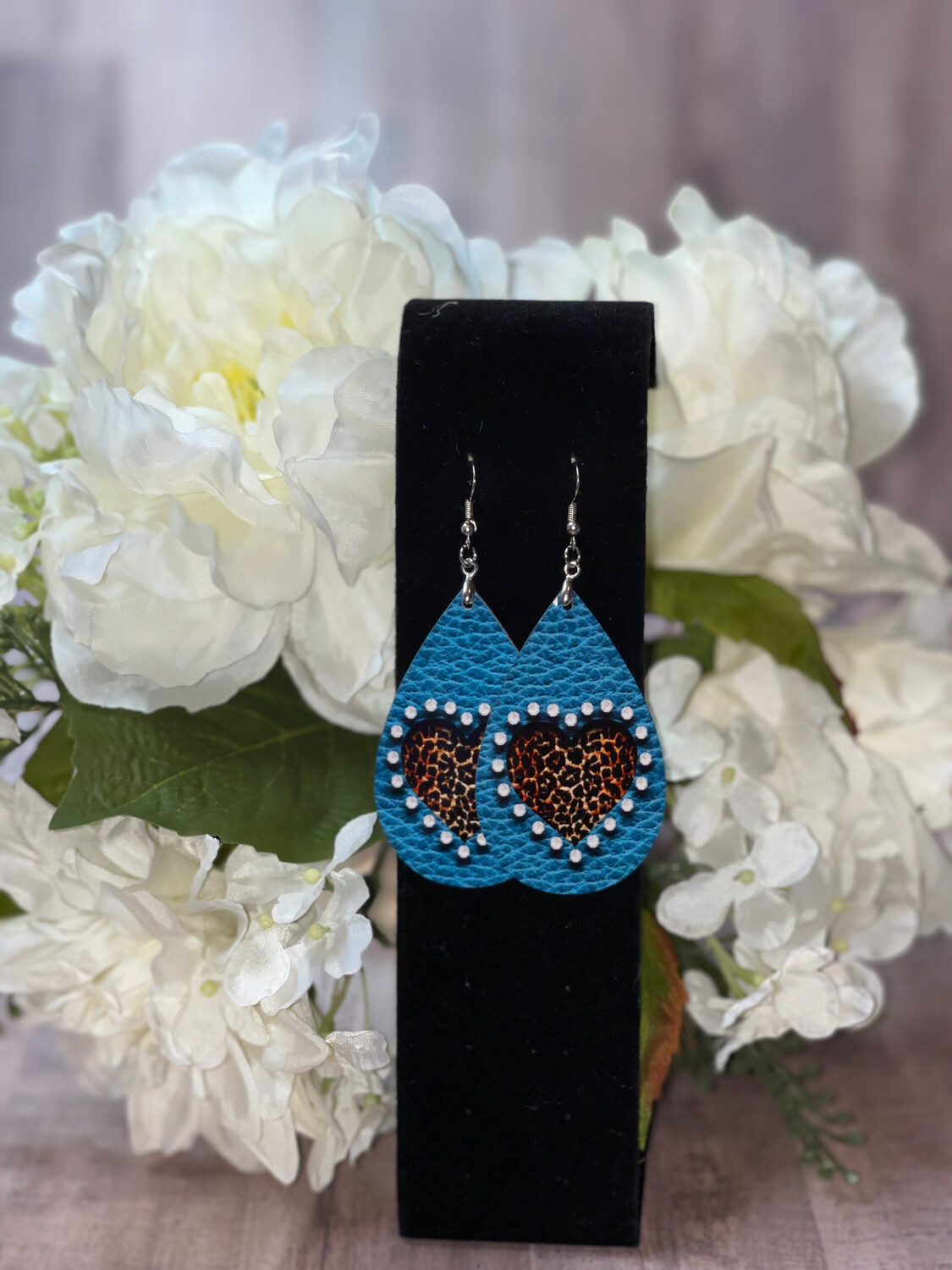 Turquoise Faux Leather Background With Cheetah Heart Earrings