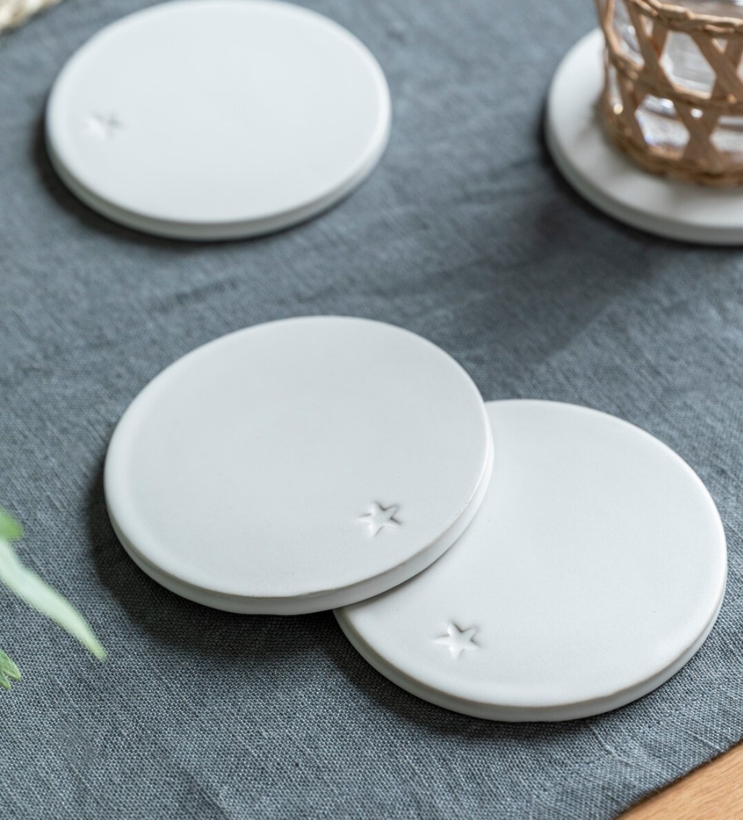 SET OF 4 WHITE CERAMIC COASTERS SET OF 4 WHITE CERAMIC COASTERS