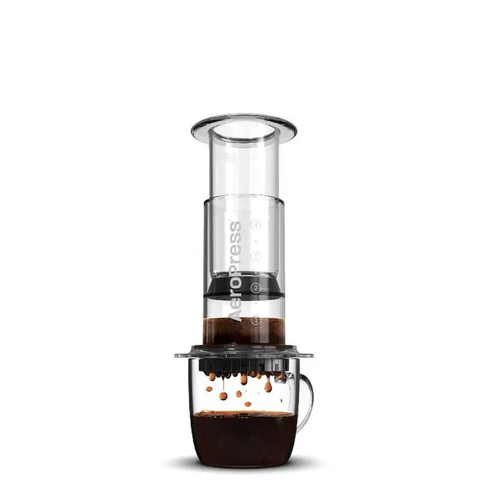 AeroPress Clear coffee maker brewing into a clear glass mug