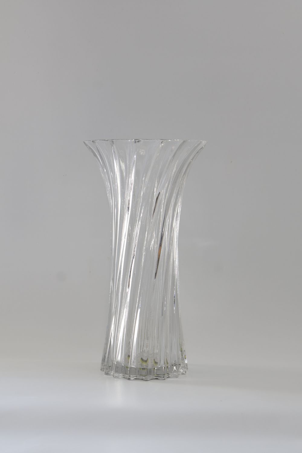 Tall, clear glass vase with a twisted fluted design.
