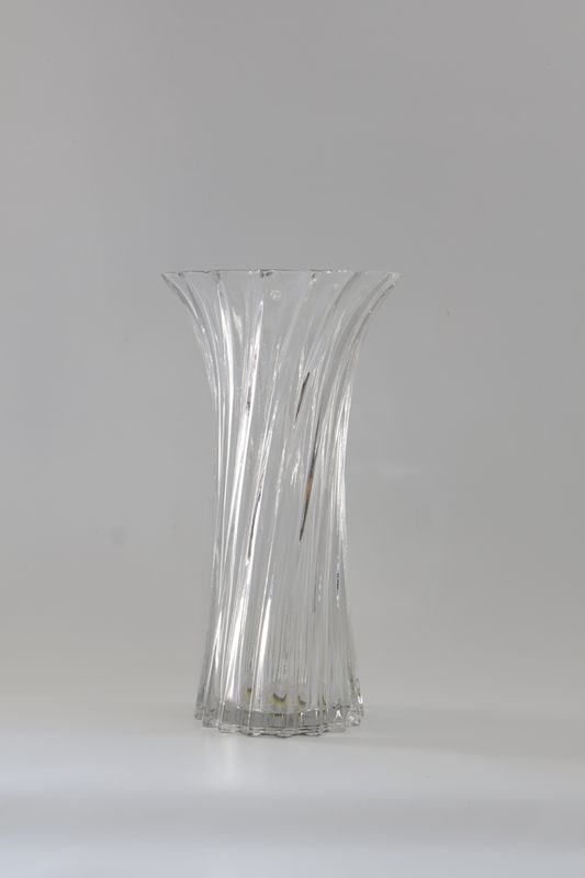 Tall, clear glass vase with a twisted fluted design.