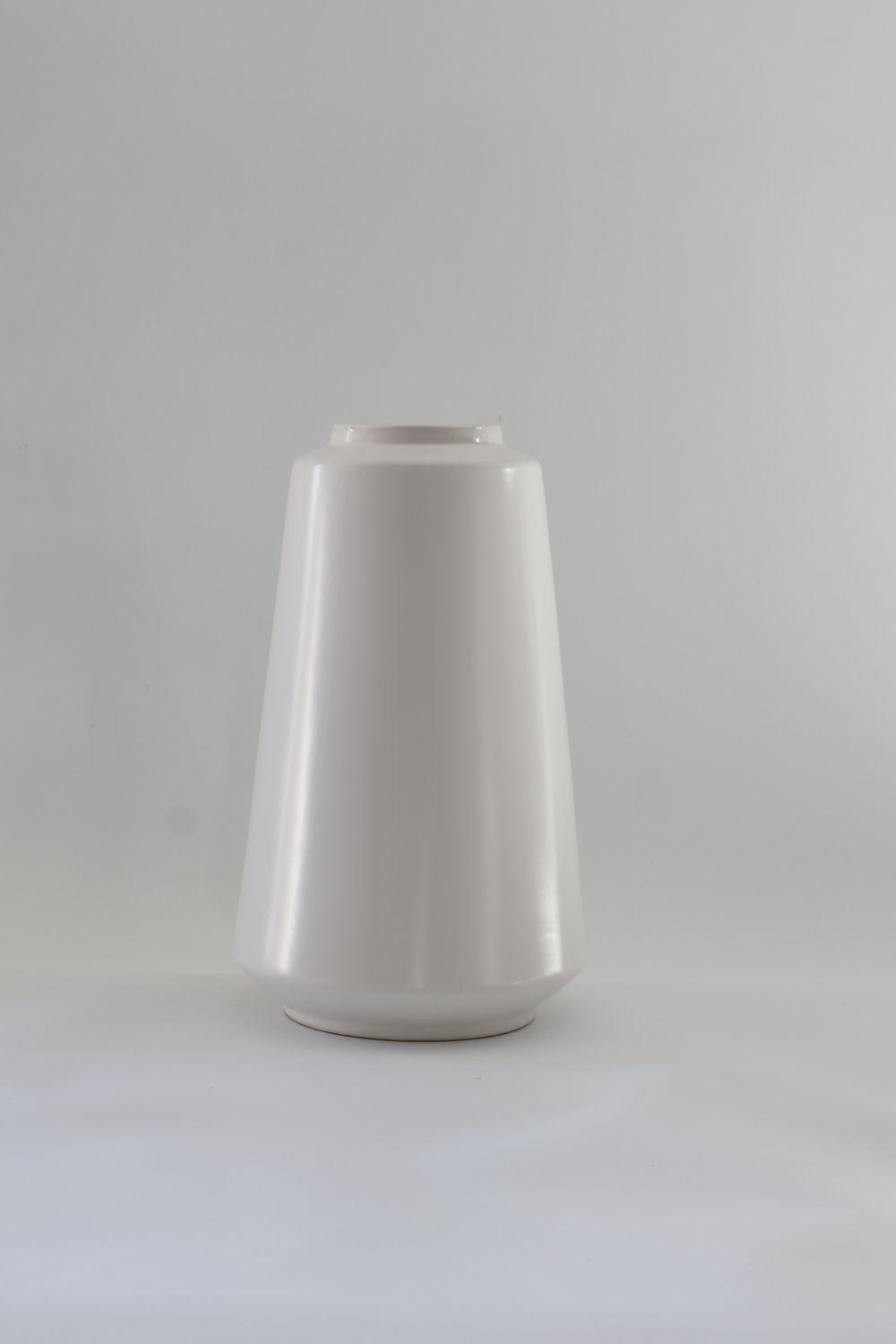 Modern tapered ceramic cylinder design with a stepped lip.