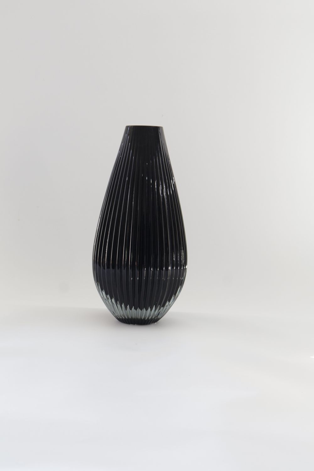 ​Tear-drop-shaped vertical fluted or ribbed modern glass design.