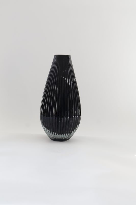 ​Tear-drop-shaped vertical fluted or ribbed modern glass design.