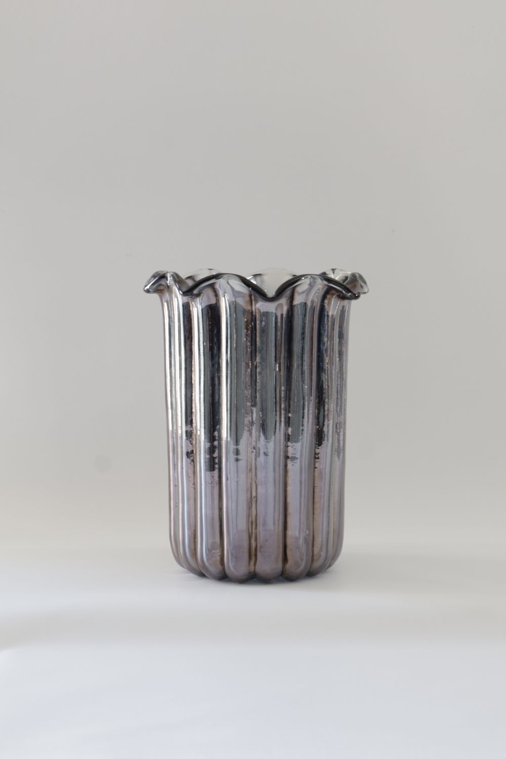 ​Metallic/iridescent smoked glass vase features a textured, ribbed cylindrical design.