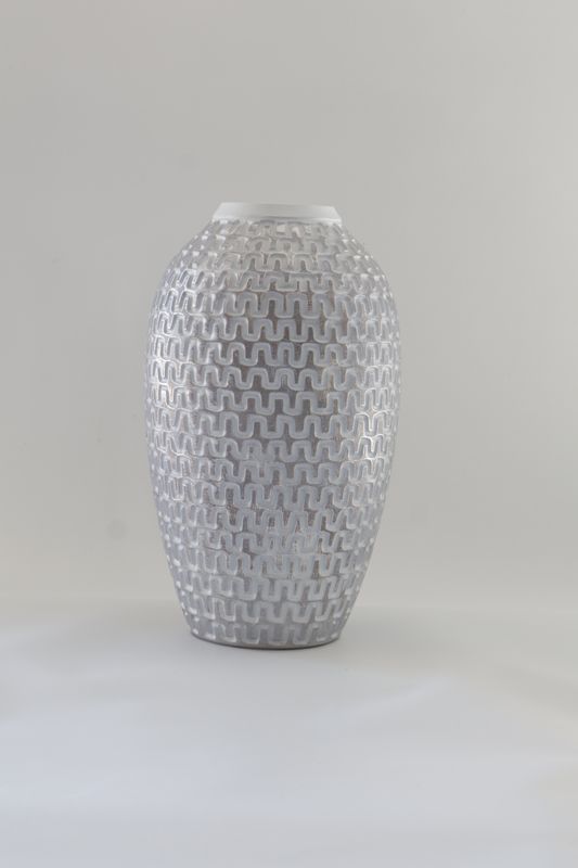 Ceramic vase features a tall, tapered silhouette with an intricate geometric woven texture.