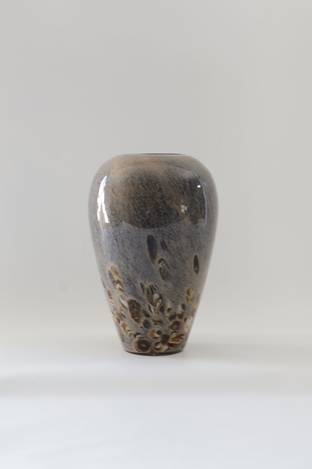 ​Egg-shaped art glass vase with a slightly tapered rim and base.