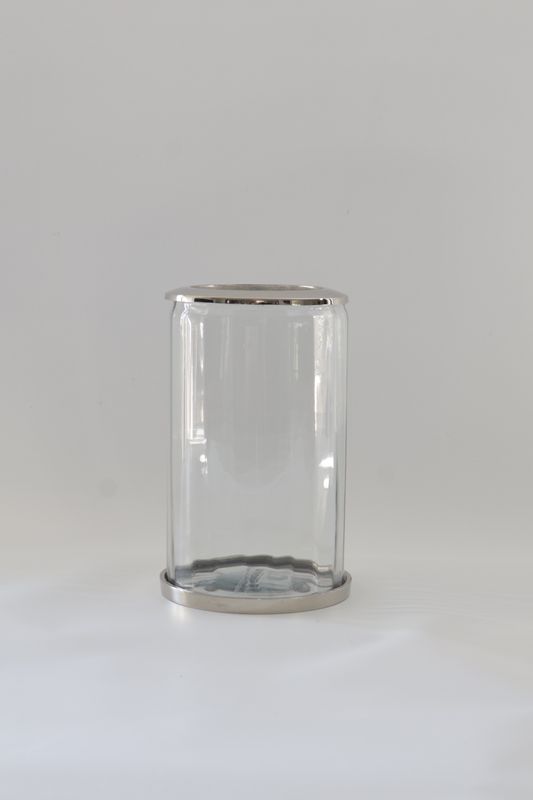 ​Minimalist straight-sided glass cylinder with metallic trims.