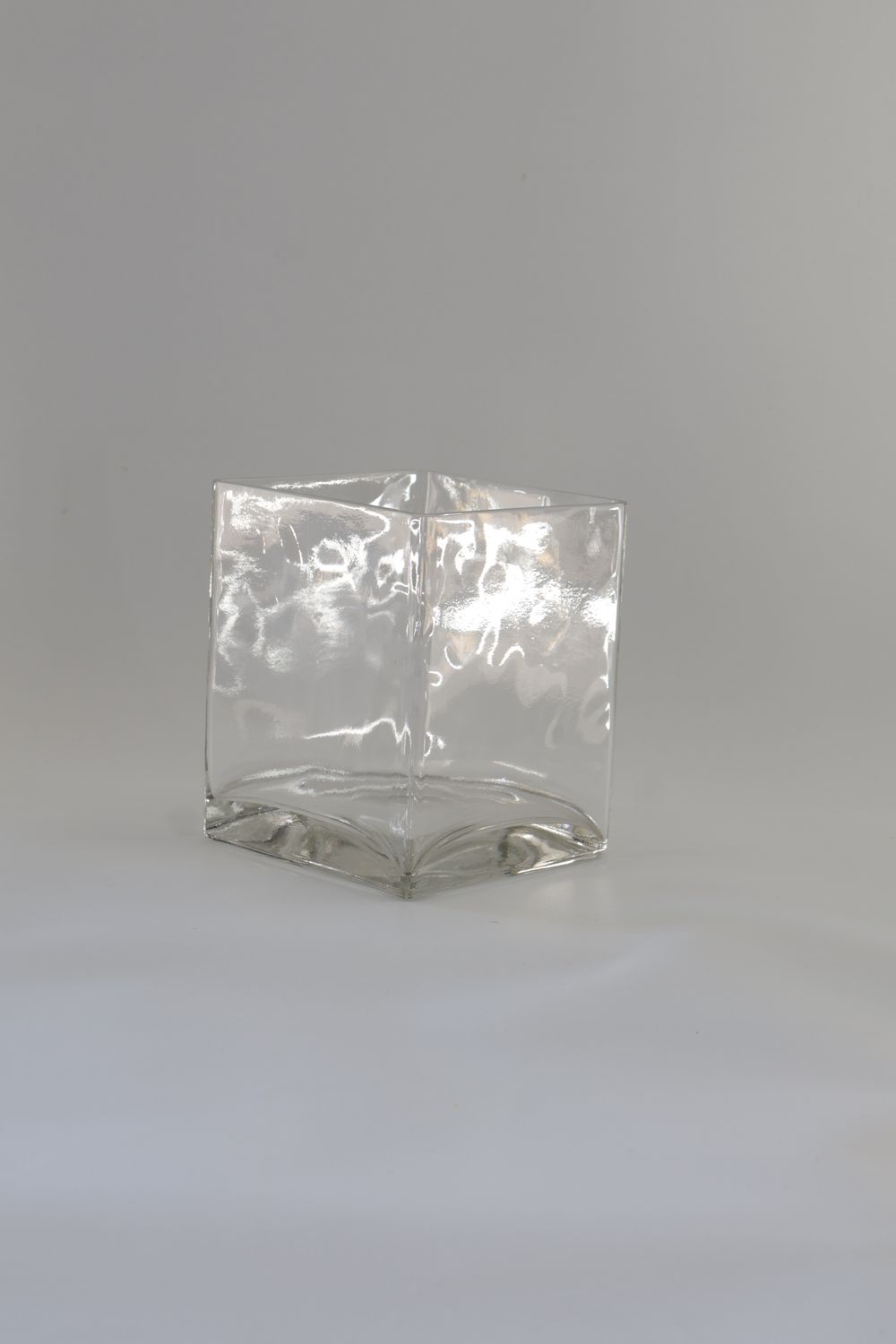 Modern cube-shaped glass vessel design with a heavy base.