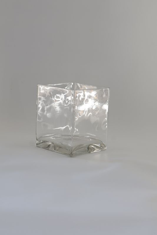 Modern cube-shaped glass vessel design with a heavy base.