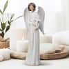ANGEL FIGURINE IN WHITE DRESS HOLDING A CROSS