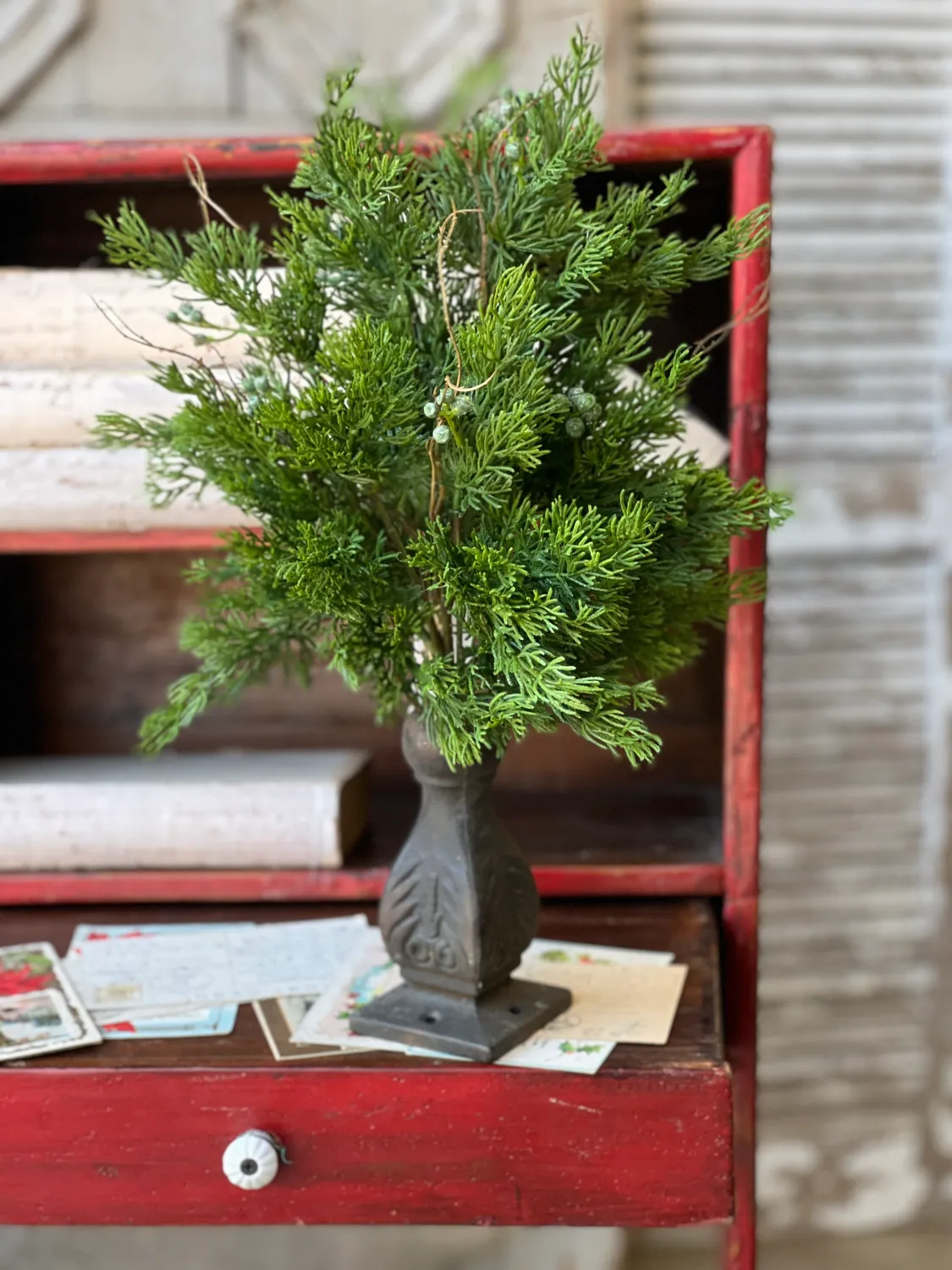 Dripping Cedar Bush I 17", a decorative accent with soft, cascading cedar-style foliage, from Lancaster Home, in a dark vase.
