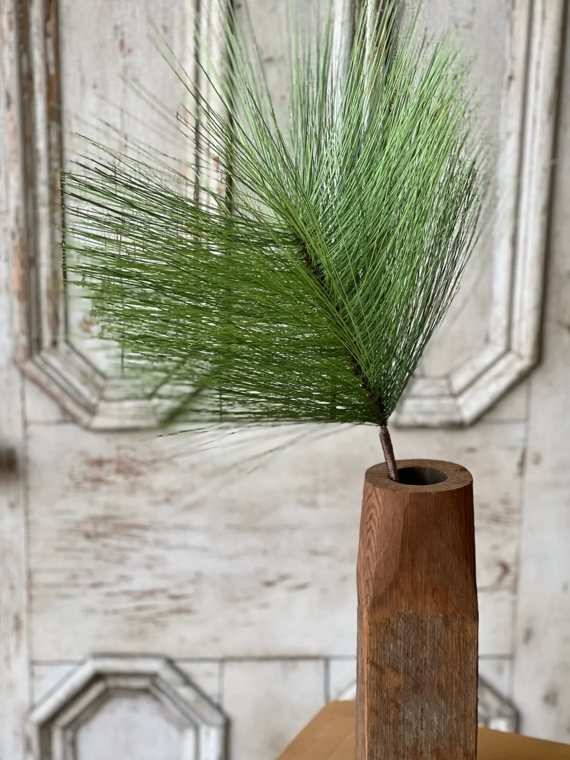 Bursting Pine Spray I 28" green pine stem in a wooden vase, featuring a full and airy pine-inspired look.