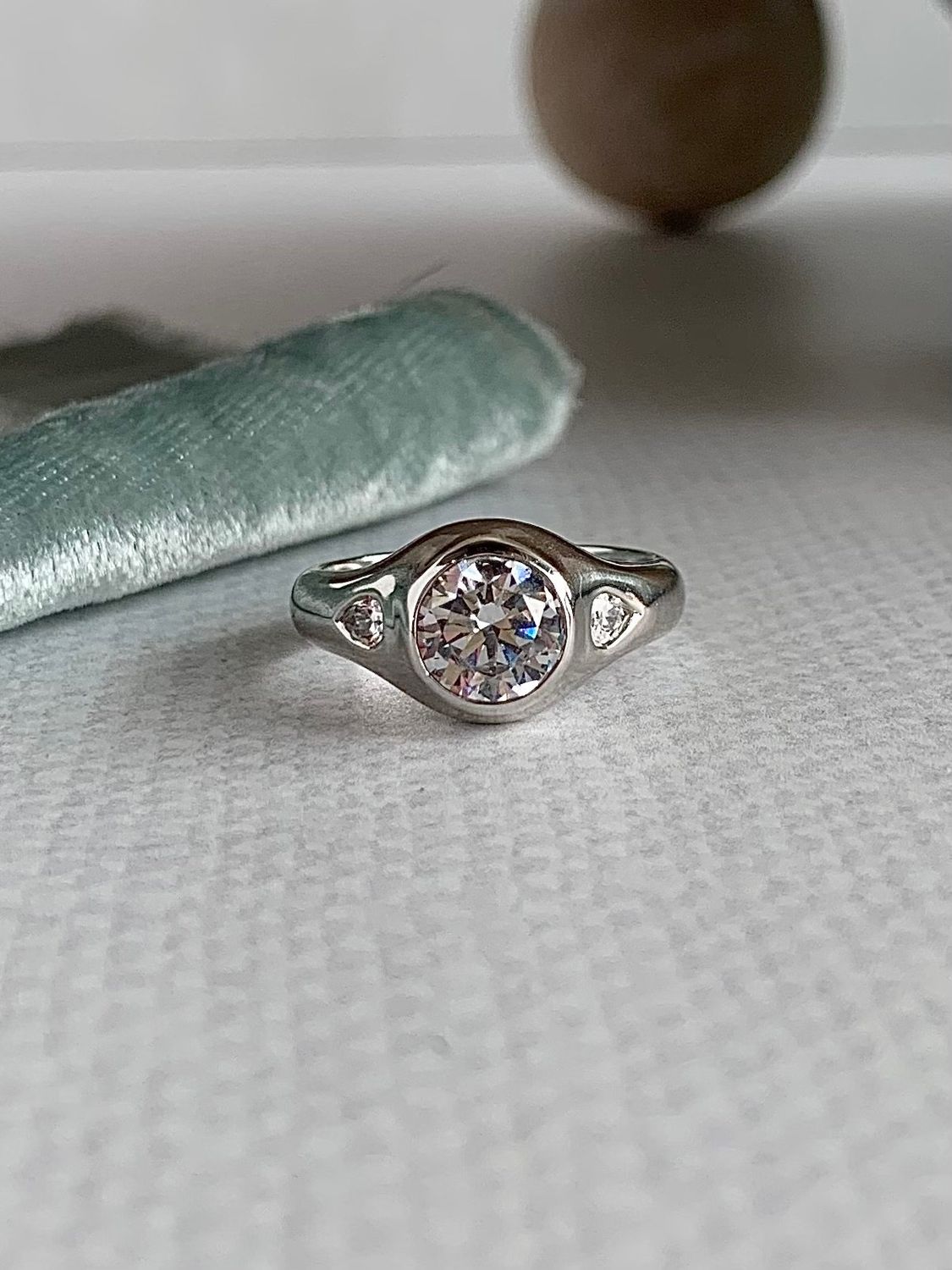 Quinn Round Brilliant Cut 7.4mm Moissanite Center with Pear Cut Moissanite Accents 14k White Gold Dome Engagement Ring