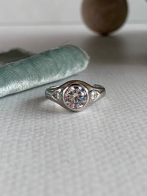 Quinn Round Brilliant Cut 7.4mm Moissanite Center with Pear Cut Moissanite Accents 14k White Gold Dome Engagement Ring