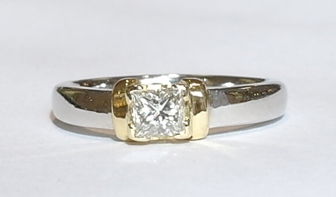 Platinum and 18ct princess cut solitaire ring