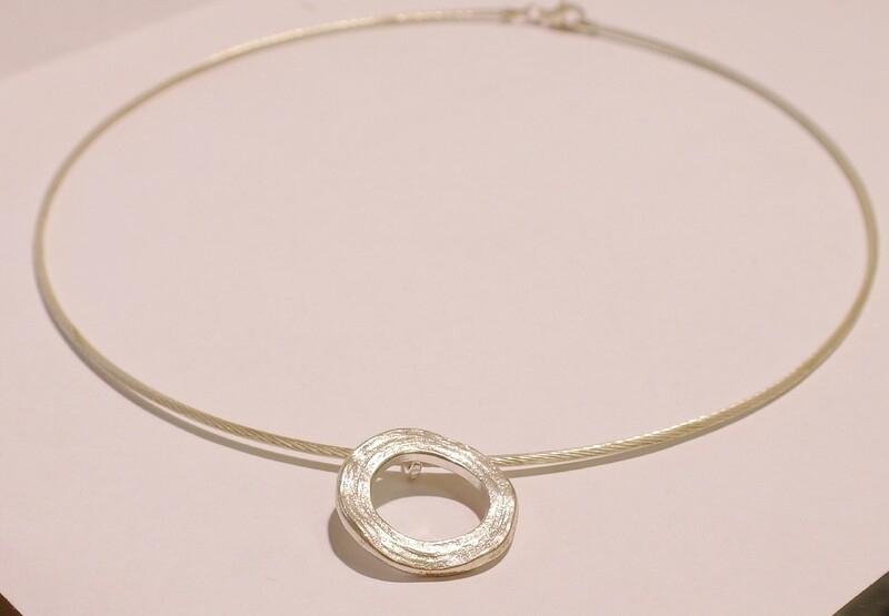 Silver pendant on a wire collar