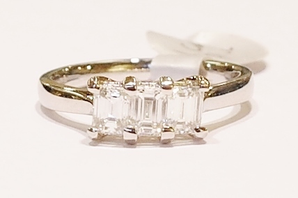 Platinum emerald cut three-stone diamond ring