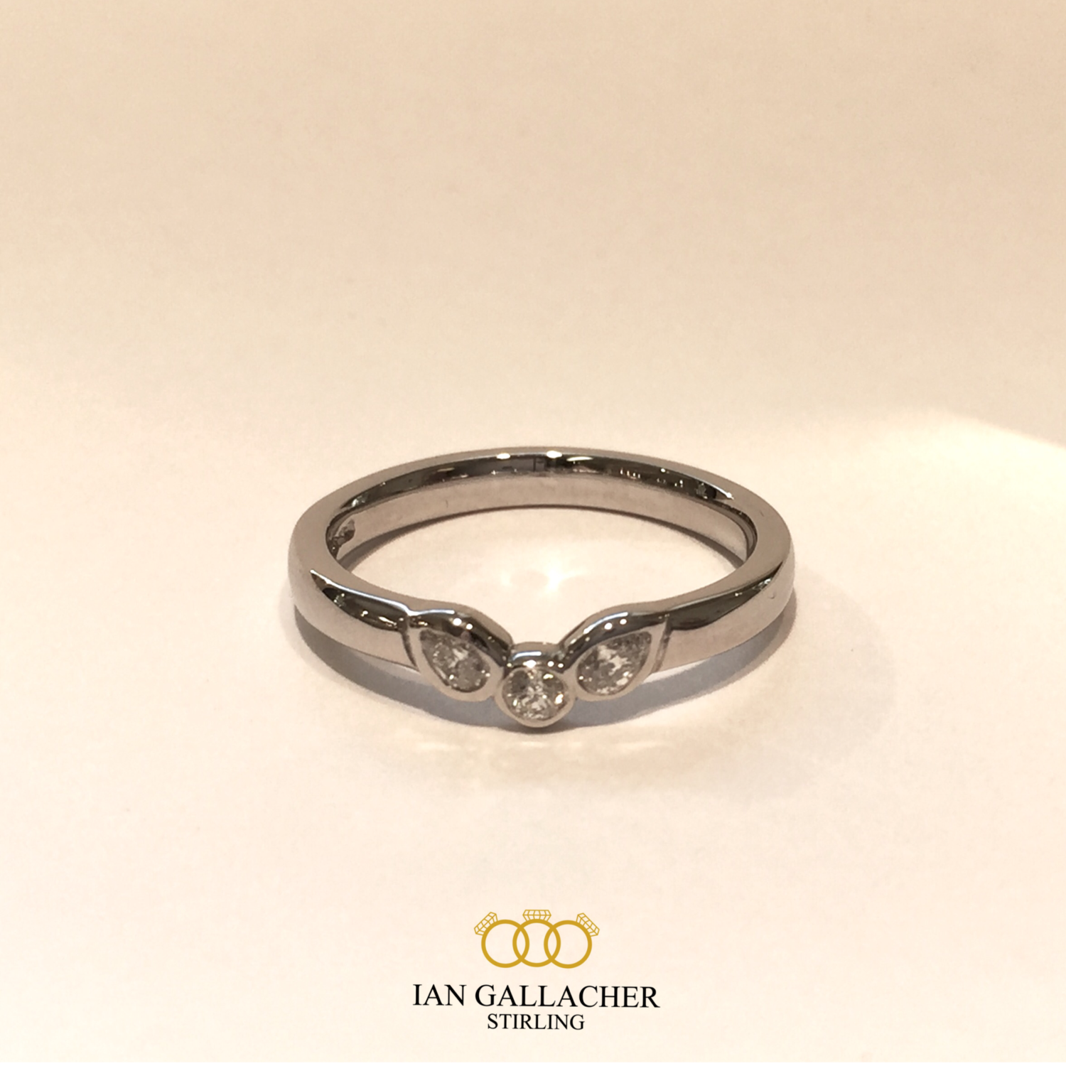 Platinum brilliant and pear cut diamond shaped wedding ring