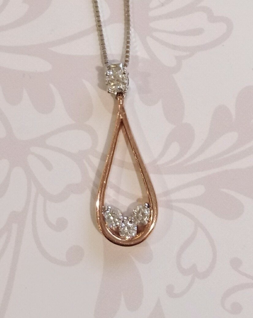 Rose and white gold pear shaped pendant.