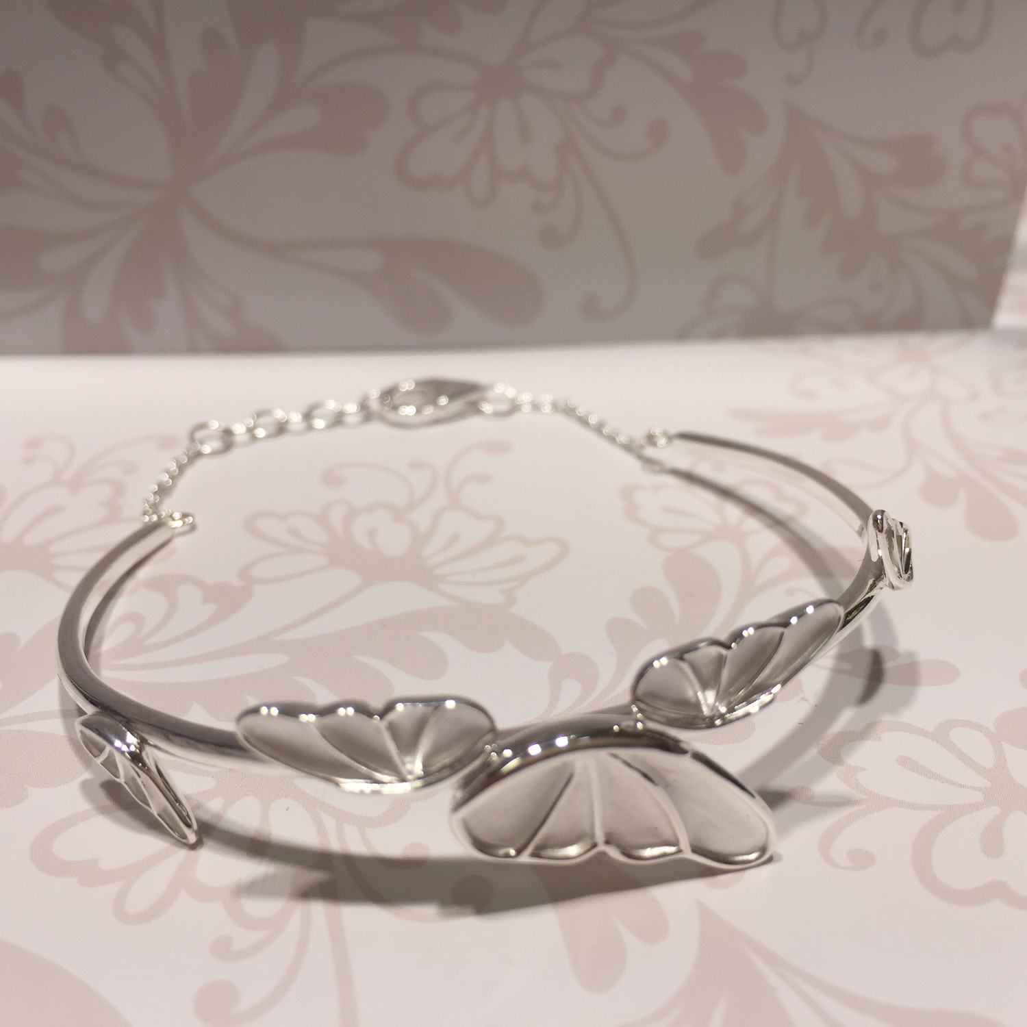 Silver bangle with butterfly wings
