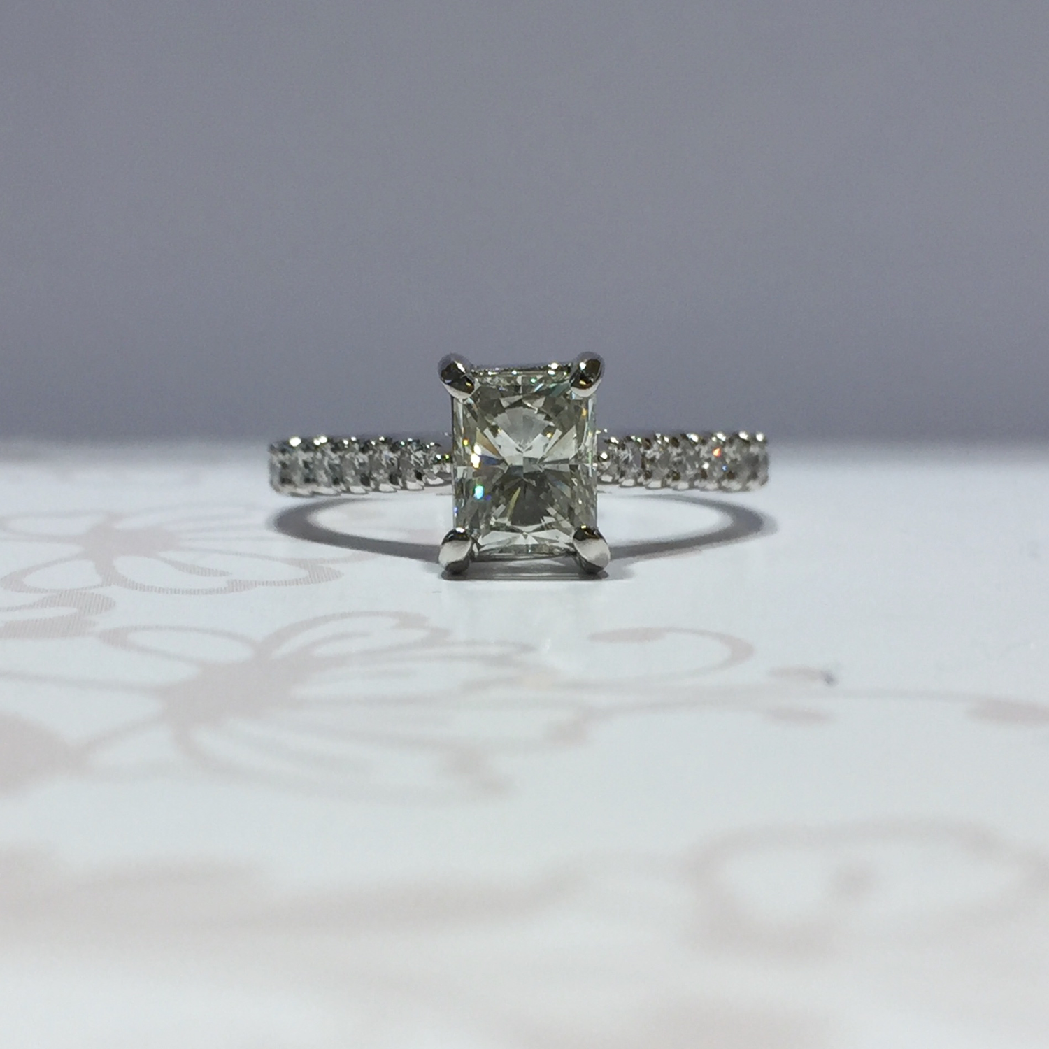 Platinum radiant cut diamond ring with diamond shoulders