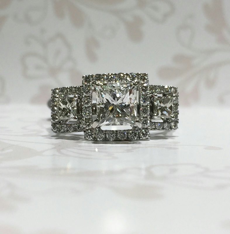18ct white gold princess cut diamond trilogy ring with diamond halos