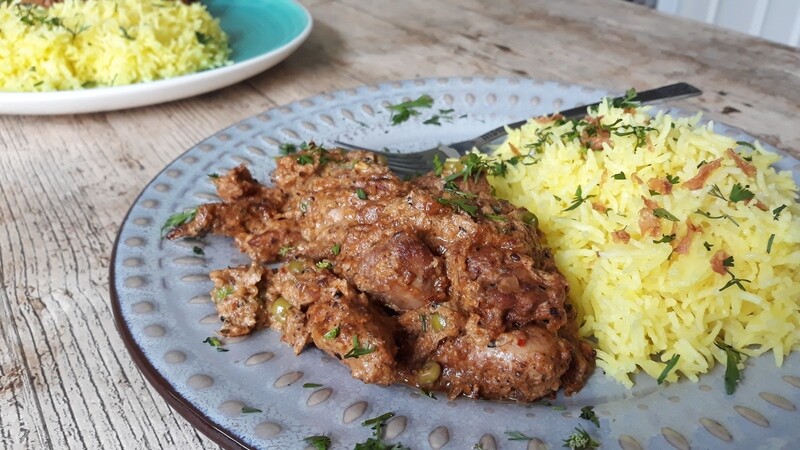 plate of panch phoran chicken served with rice. made with a Case for Cooking spice kit.
