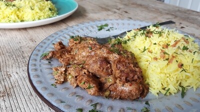 plate of panch phoran chicken served with rice. made with a Case for Cooking spice kit. 