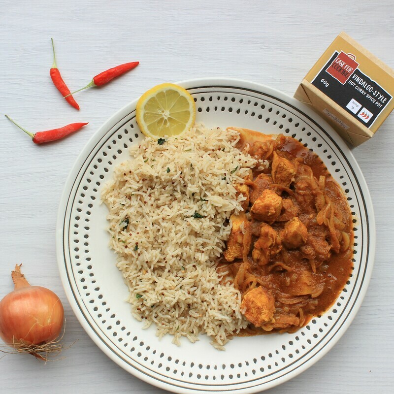 plate of chicken vindaloo served with rice and made with a Case for Cooking curry spice pot