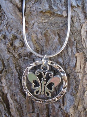 Pewter butterfly encircled in textured ring and hanging on 925 silver snake chain