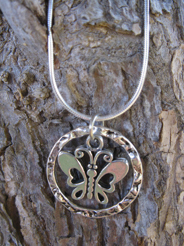 Pewter butterfly encircled in textured ring and hanging on 925 silver snake chain