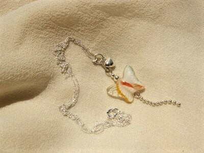 This beautifully delicate glass and sterling-silver butterfly is accompanied by a tiny heart
