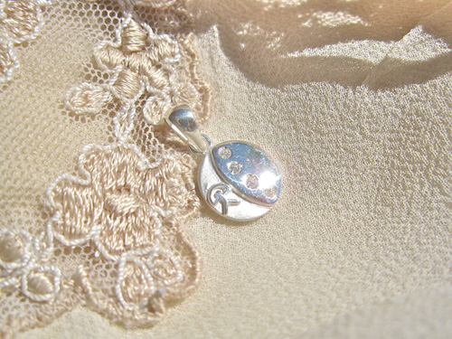 Button pendant ~ lucky Indalo, silver