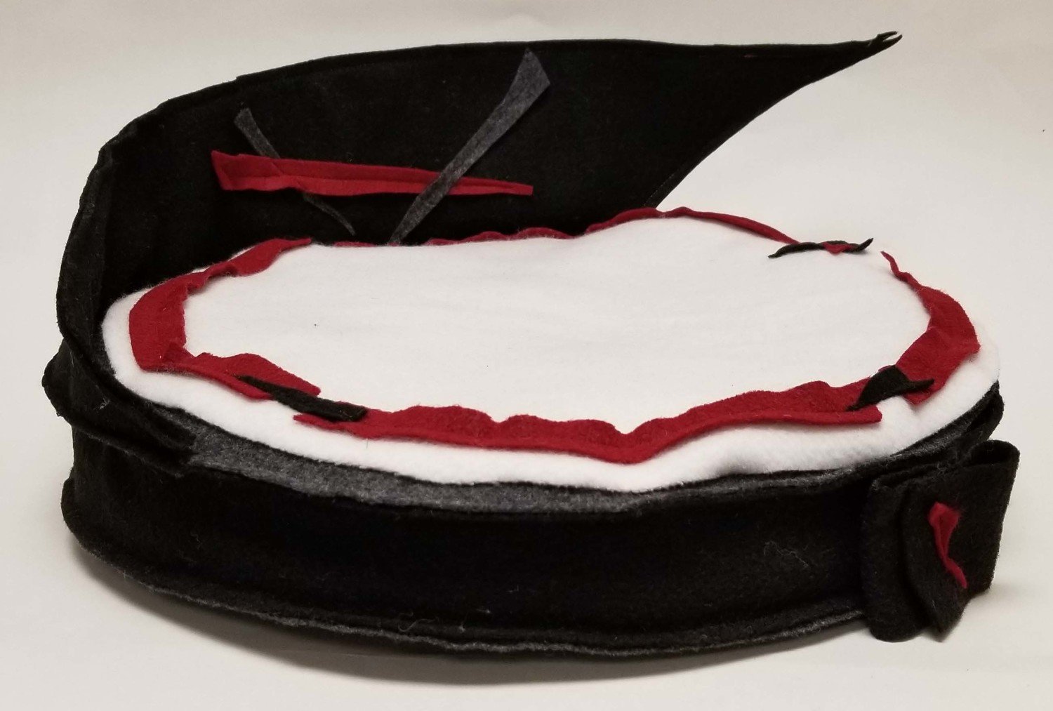 ROUND BLACK AND RED BED WITH PARTIAL BACK