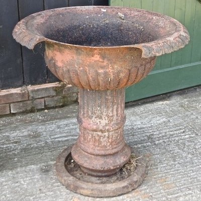 Lot 2,   A Victorian painted cast iron garden urn, on a pedestal base, 78cm diameter 100/150