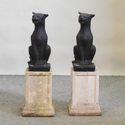 Lot 6,   A pair of black painted reconstituted stone models of cats, each on a pedestal base, 86cm high  120/180