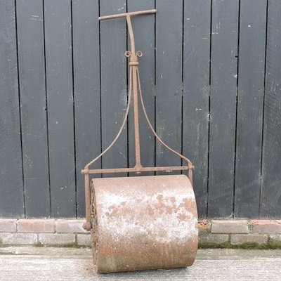 Lot 16,   An antique cast iron garden roller, 63cm wide 30/40