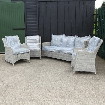 Lot 20,   A grey rattan three seater sofa, 182cm, together with three armchairs, with loose cushions 150/250