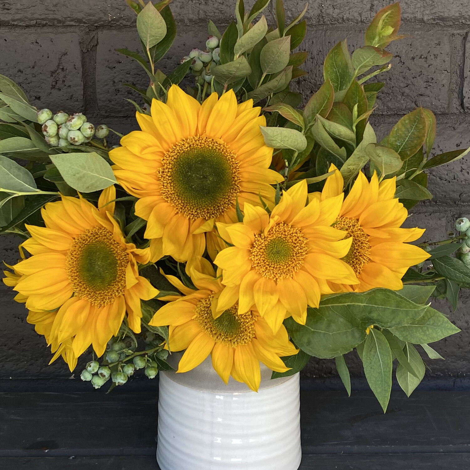 LOCAL SUNFLOWERS IN CERAMIC VASE