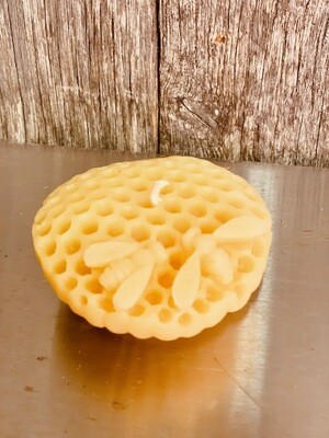 Honeycomb with bees floating beeswax candle