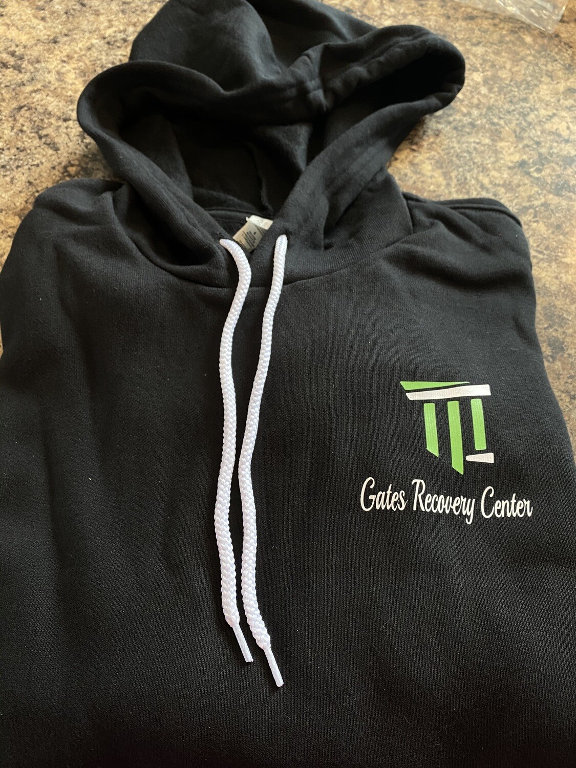Gates Recovery Center hooded long sleeve logo over the heart logo - BLACK