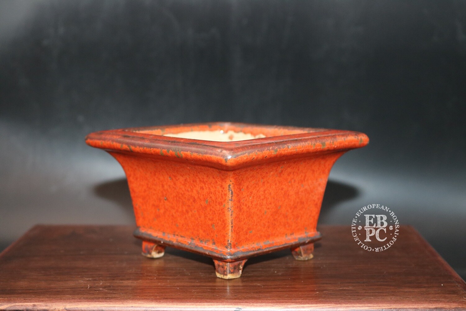 Ian Baillie - 12.6cm; Glazed; Square; Semi cascade; Vivid Red; Silver crystal flecks; Basal band; Recessed feet;