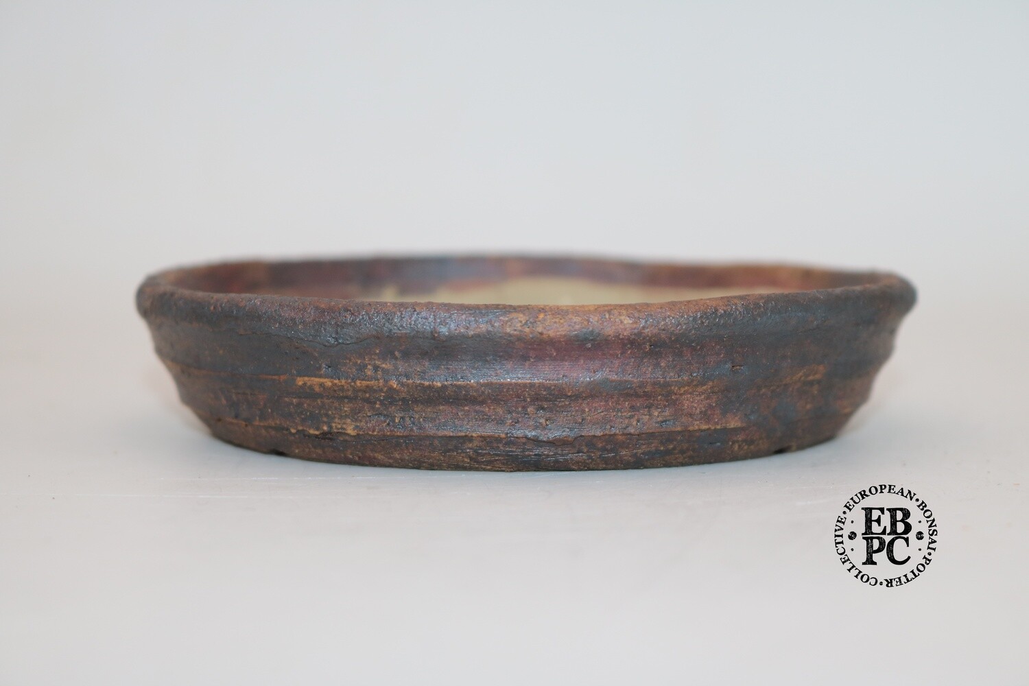 SOLD - Ian Baillie - 13.3cm; Nanban; Round; Rippled banding; Oxide Wash; Browns; Greys; Red tones;