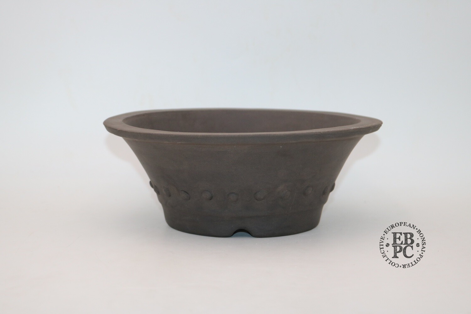 SOLD - Zey Ceramics - 24cm; Unglazed; Round; Rivets / Studs; Dark Brown Clay; Lip to Rim; Integrated foot ring;