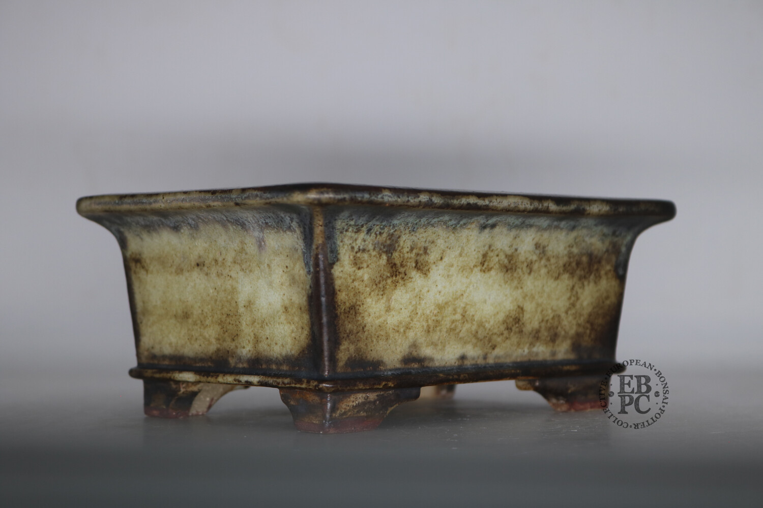 Ian Baillie - 19cm; Glazed; Rectangle; Deep profile; Stunning Antique Cream Glaze; Browns; Basal Band; Extended Lip; Carved Feet; EBPC Stamped 