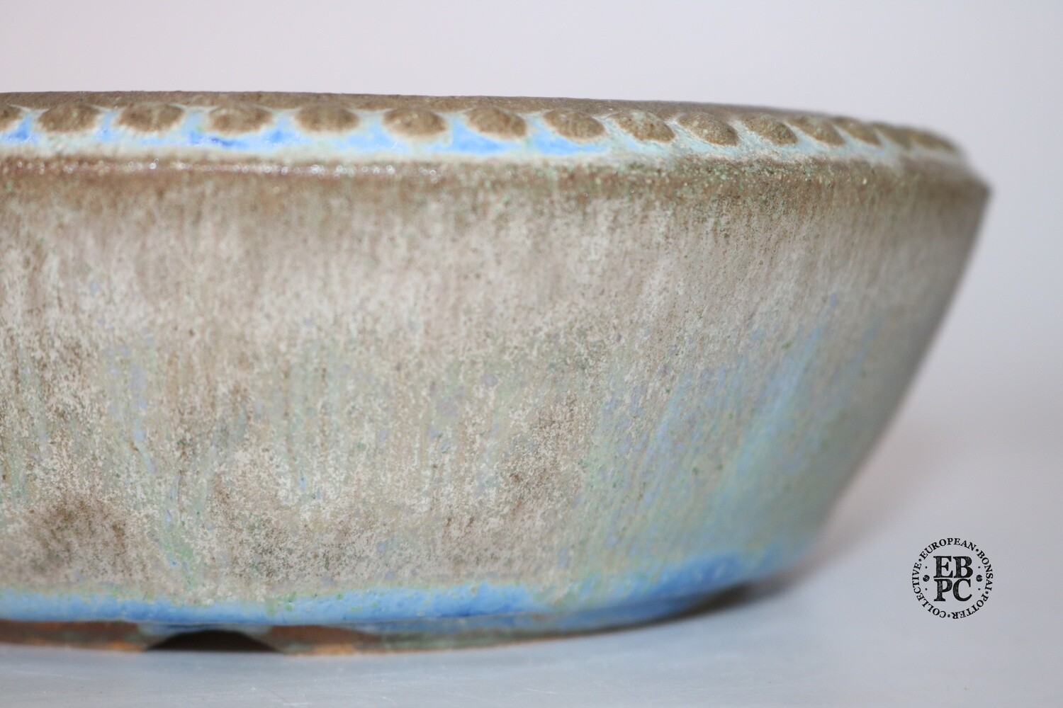 Fukurou Ceramics - Switzerland. 18cm; Round; Studs to Bevelled Rim; Foot Ring; Arch-cut Feet; Exquisite Glaze; Cream; Greens; Browns; Dynamic Sky Blue; Made by Patrik Lüthi.