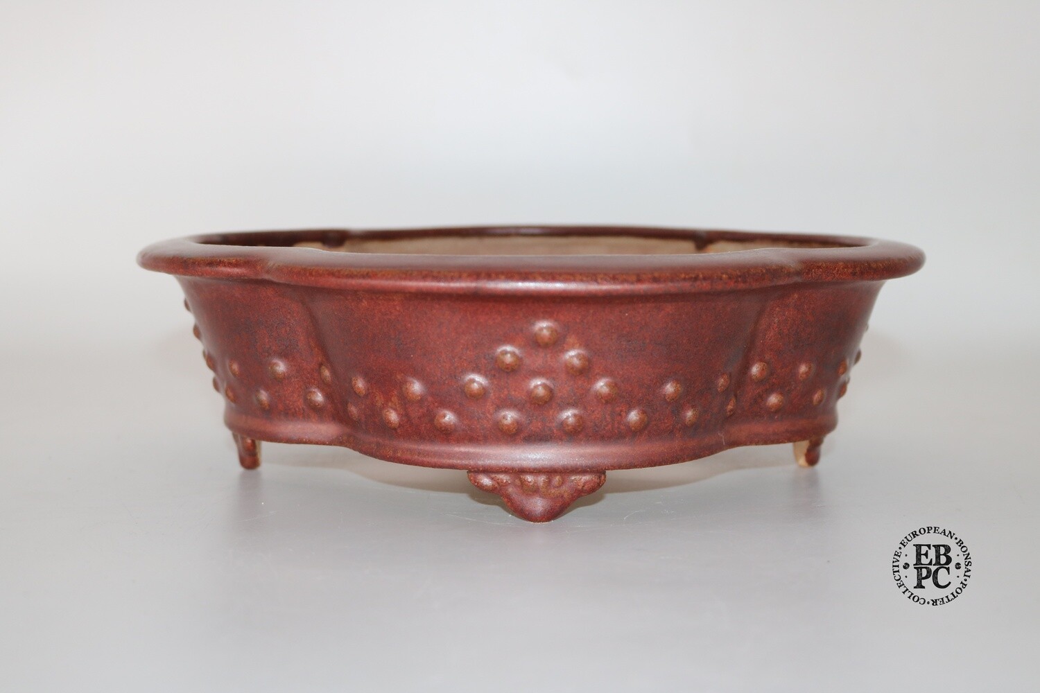 Fukurou Ceramics - Switzerland. 25.3cm; Hand-made; Mokko; Formal Studs Design; Lip to Rim; Basal Band in Relief; Cloud Feet; Glazed; Deep Burgundy Red; EBPC Stamped; Patrik Lüthi